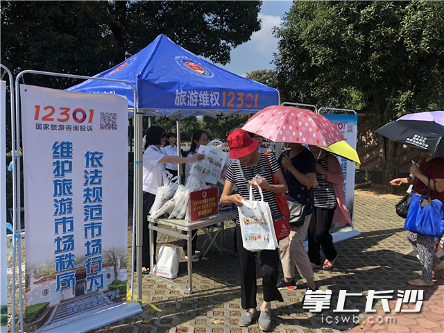 游客纷纷来到长沙市旅游质监所咨询台领取12301旅游维权宣传品。 游客纷纷来到长沙市旅游质监所咨询台领取12301旅游维权宣传品。