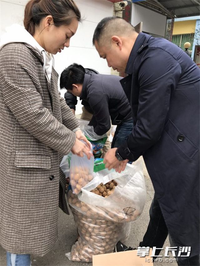 社区工作人员及驻社区民警将物资进行装袋。