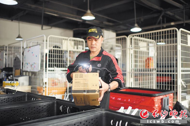 在顺丰速运三兴街营业部，邓石山在分拣包裹。  长沙晚报全媒体记者 黄启晴 摄