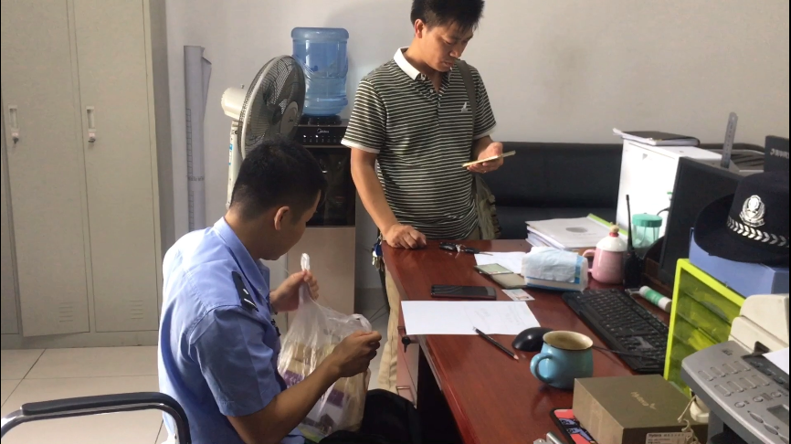 黄女士的亲属来到派出所，领回了遗失的双肩包及包内物品。 警方供图