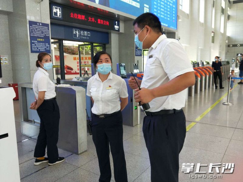 周立翔（右）与同事交流工作。 长沙晚报实习生 何欣 记者 周和平  摄影报道