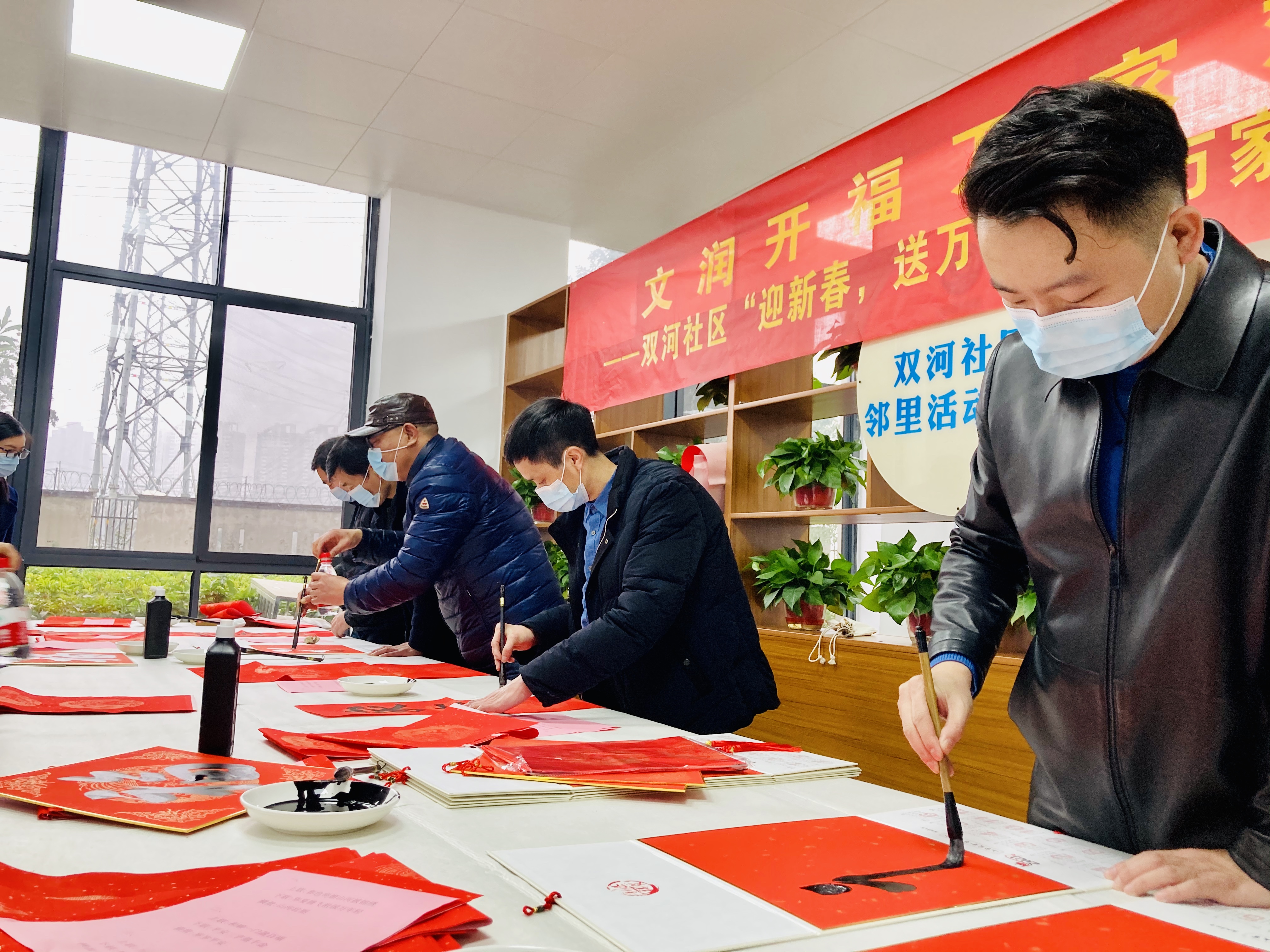 书画名家走进“留守幸福家”，为就地过年人士和居民写春联送福。 