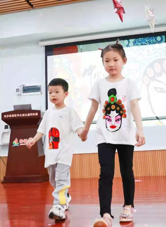 孩子们身着各种类型的涂鸦T恤，自信满满地走上舞台。