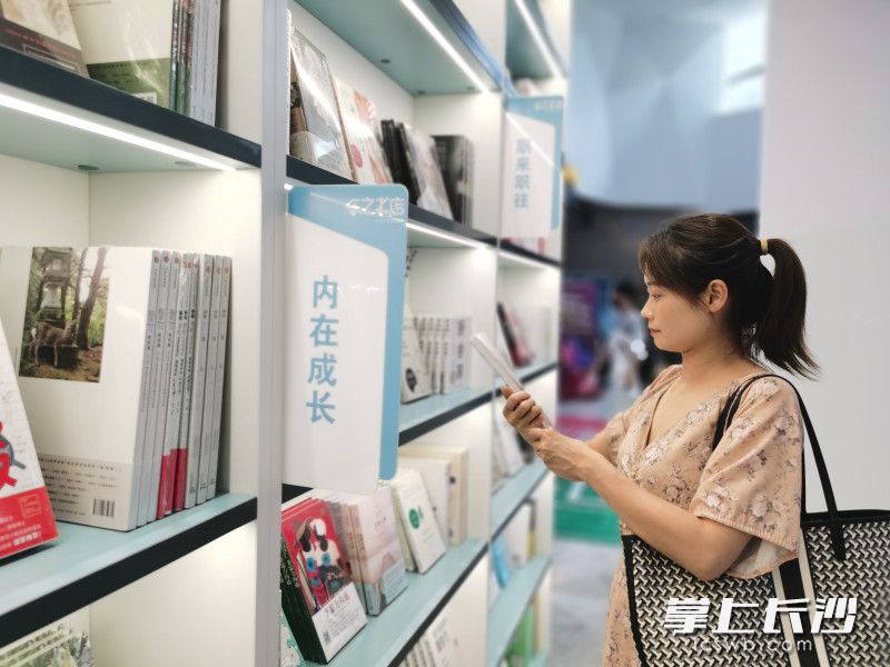 读者翻阅书架上陈列的书籍。