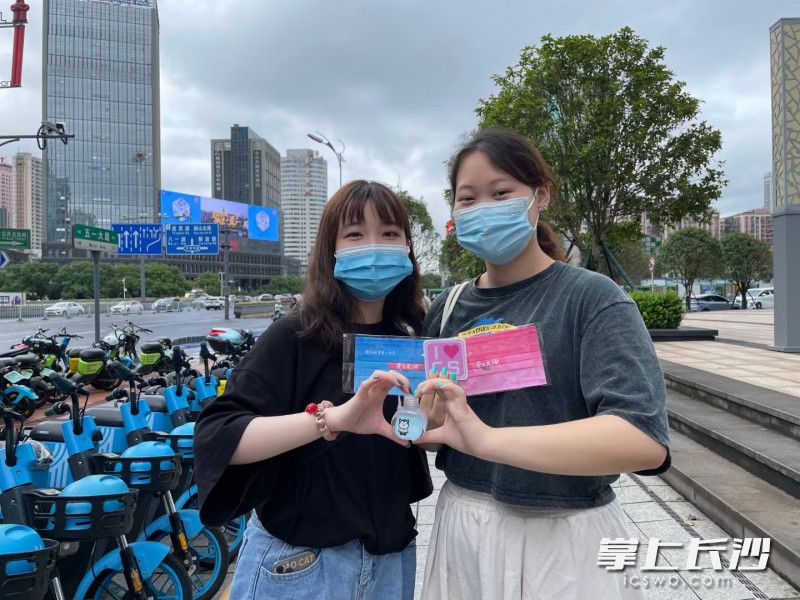 收到惊喜小礼物的长沙市民在镜头前比心。