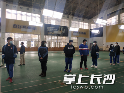 学生们保持安全距离，等待检测。