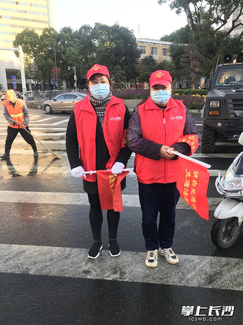 雷锋志愿者吴惊丽在八一路韶山路口维护交通。（左一）