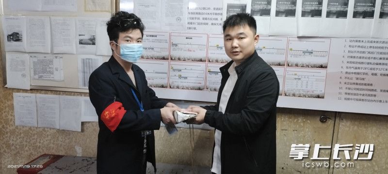 19日下午，市民张造民来到140路终点站，从司机李尚希手上拿回了妻子的包。受访者供图