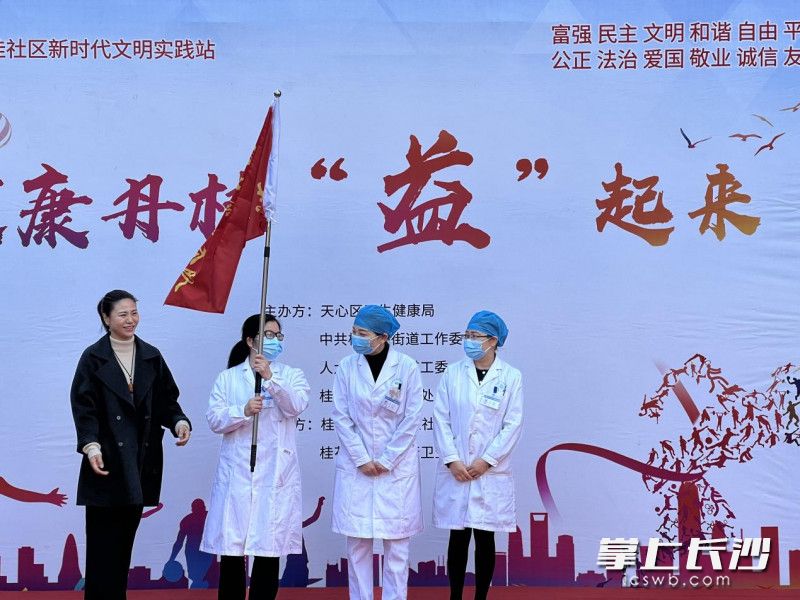 街道工委书记周钰沂为百康卫生服务中心授予“健康卫士”服务队旗帜。长沙晚报通讯员 刘畅 供图