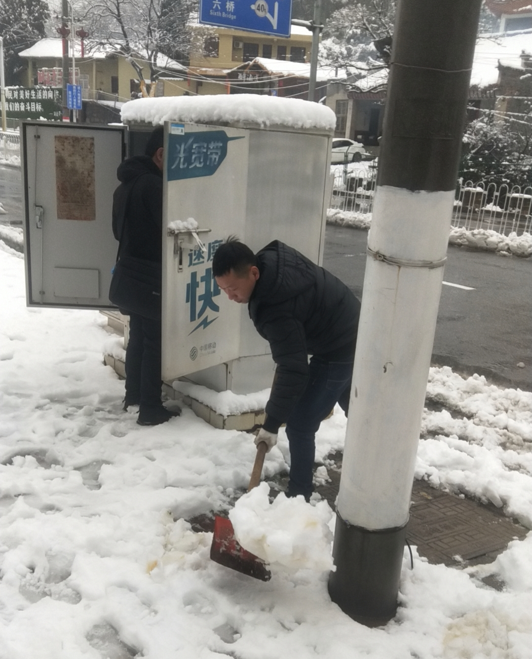 长沙移动工作人员抢修中断光缆，清理路面积雪，对地下线路进行查勘。均由通讯员供图。