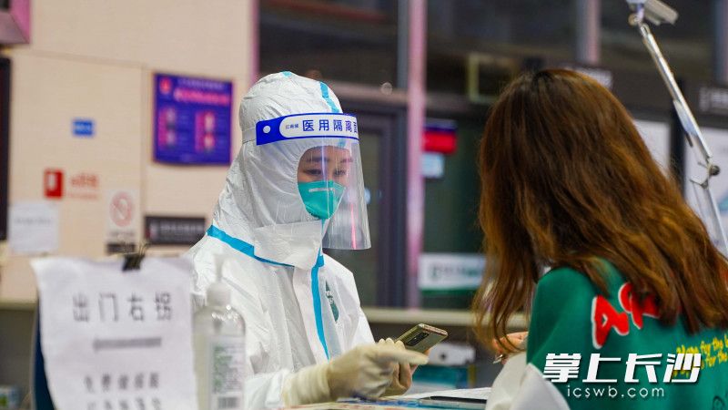 健康监测点处，检测人员正在登记旅客信息。