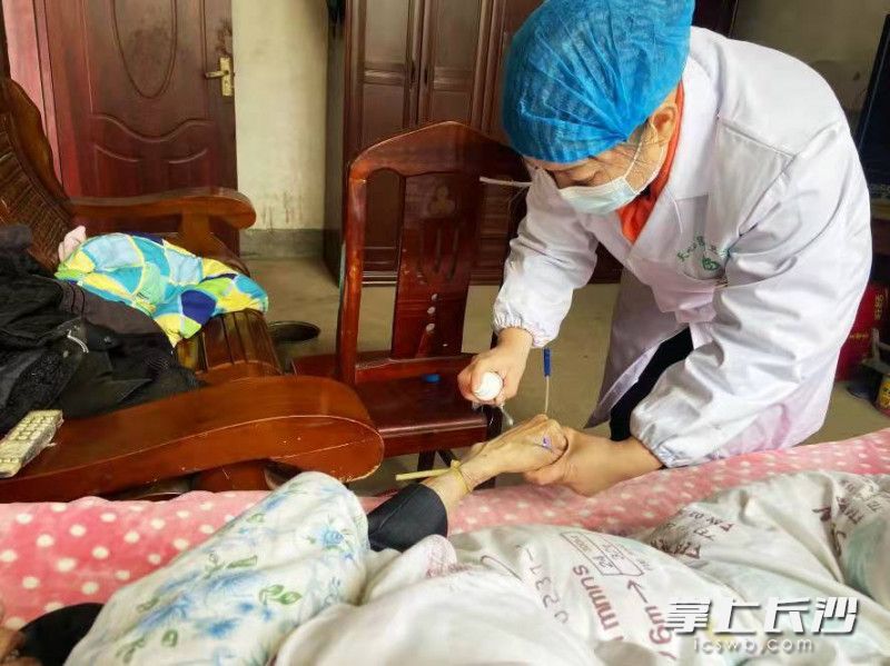 兴马洲村医颜新艳，上门为患癌老人李嗲嗲看诊输液。长沙晚报通讯员 彭银燕 摄