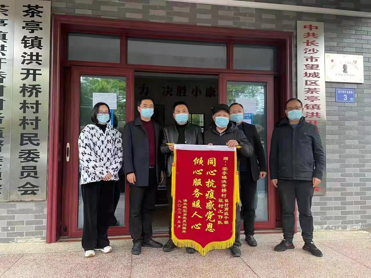 老人向战斗在抗疫一线的镇、村两级干部赠送锦旗。受访者供图
