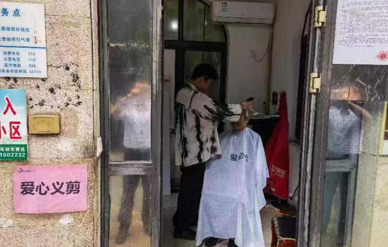 志愿者为居民义务修剪头发。长沙晚报通讯员 杨进摄