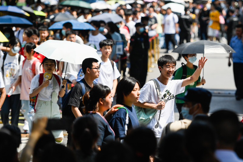 在长沙市实验中学考点，身着白色衣服的学生高兴地走出考场。