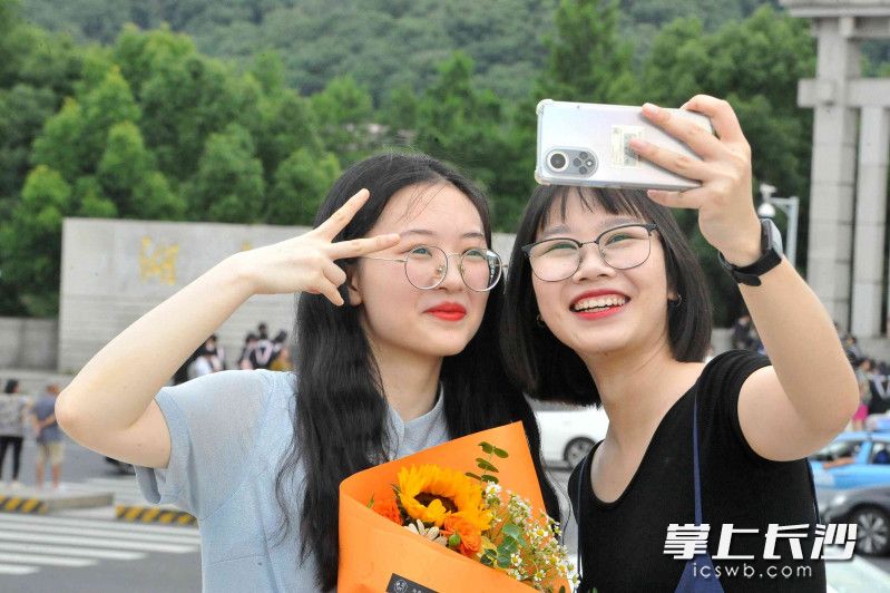 毕业生谭灵钰（左）和周雨均应聘上了广东的单位，灿烂笑容流露出心中喜悦。