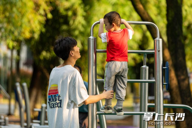 一名小孩在大人的保护下练习攀爬。长沙晚报全媒体记者 董阳 摄