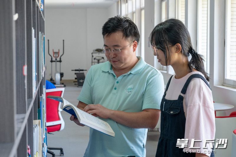 9月14日，曾铃（左）与郭海玲在图书室交流学习。均为全媒体记者 周数邑 摄