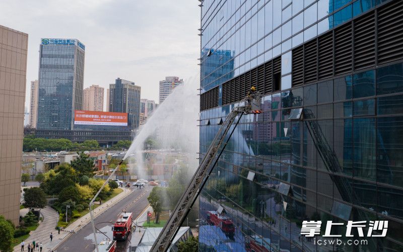 演练现场，消防救援人员利用消防云梯，从6楼避难层营救“被困者”。