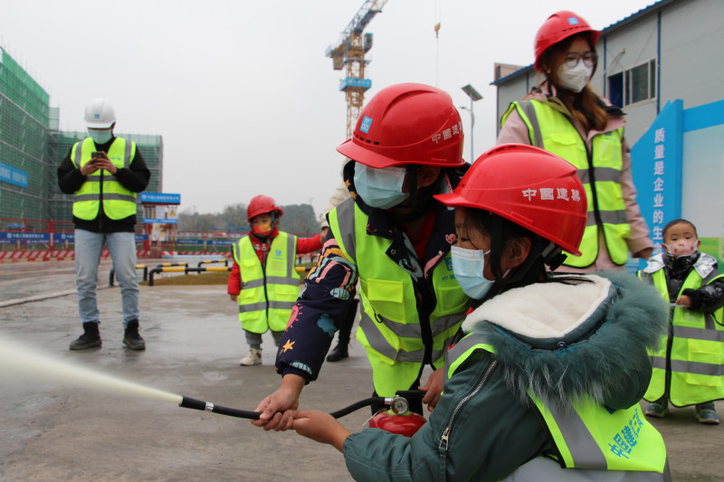 小朋友们正在学习使用灭火器。