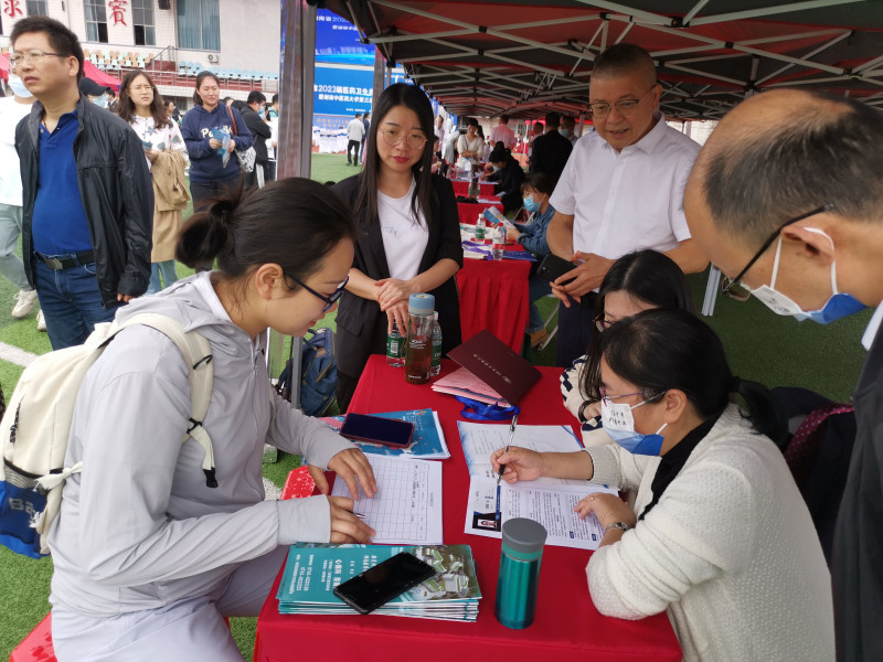 毕业生陈倩若正在新晃侗族自治县中医医院展台交流，该院党总支书记、院长杨遵勤（后排右一）正细心倾听。图片均为长沙晚报全媒体记者 徐媛 摄 