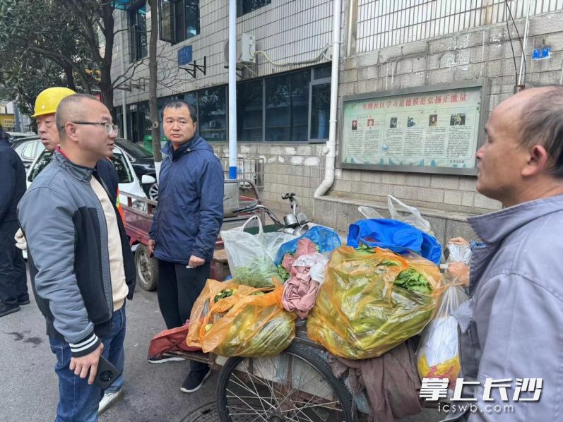 社区工作人员正在引导摊贩进入临时便民早市摆摊。长沙晚报通讯员 曹圆圆 摄
