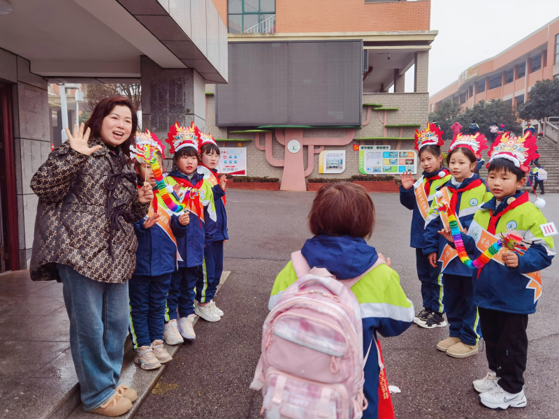 校长鲁志军和几名身披绶带的学生在校门口迎接同学们入校。均为长沙晚报通讯员 艾梦雪 供图