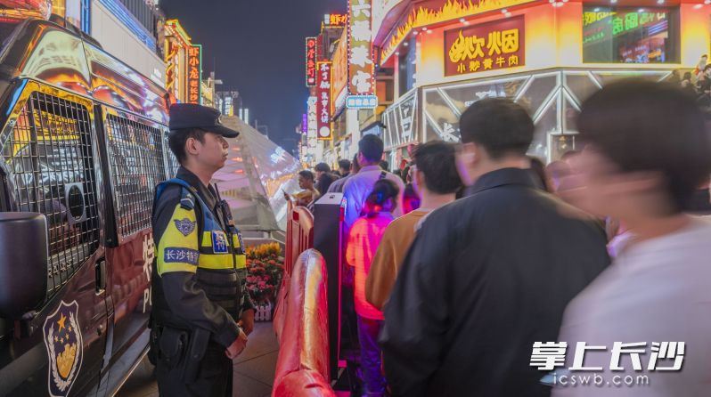 特警在人来人往的繁华街头巡逻值守。