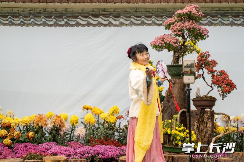 身着汉服的市民正在自己利用自拍杆合影留念。