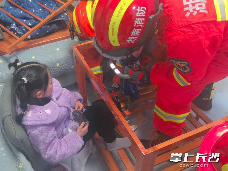 消防员对被困女童的脚进行脱困。长沙晚报通讯员 阮鹏霖 摄