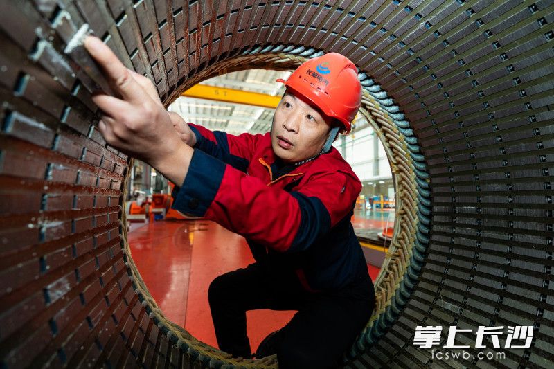 毛强正在进行电机定子内圆清洁。