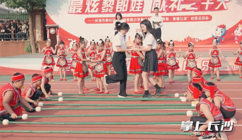 砂子塘黎郡小学师生共跳竹竿舞。