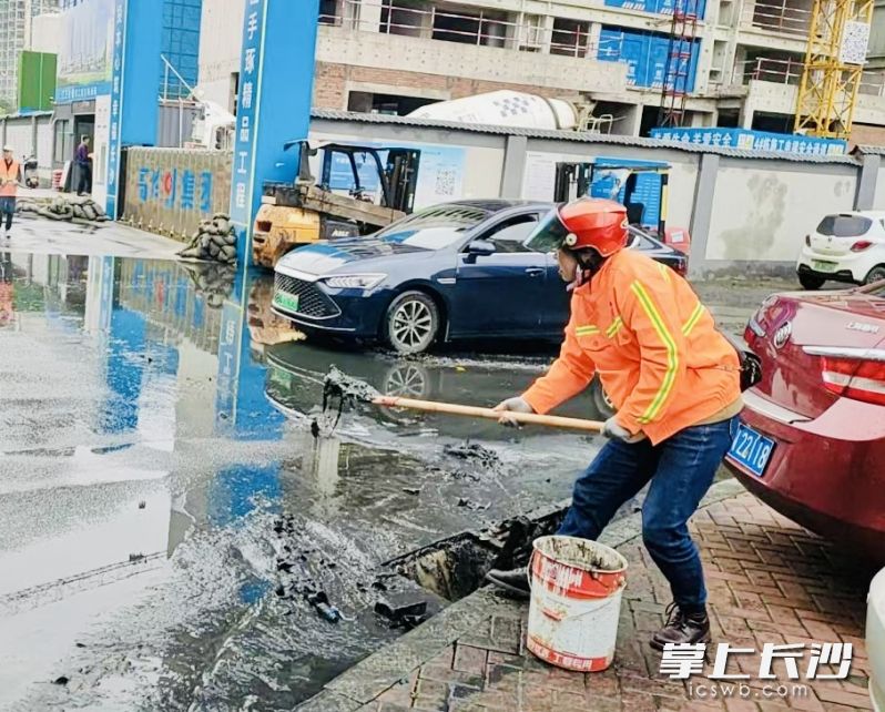开福区环卫工人清理淤泥保障排水畅通。