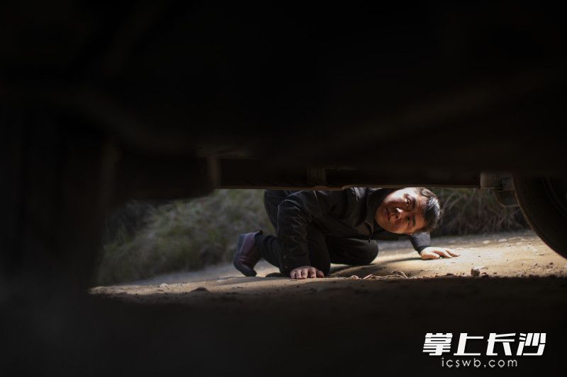 刚经过一处低洼的山地，滴滴司机周锋的停下车来观察底盘情况。他说，细心是对乘客和自己的每一次出行的保障。