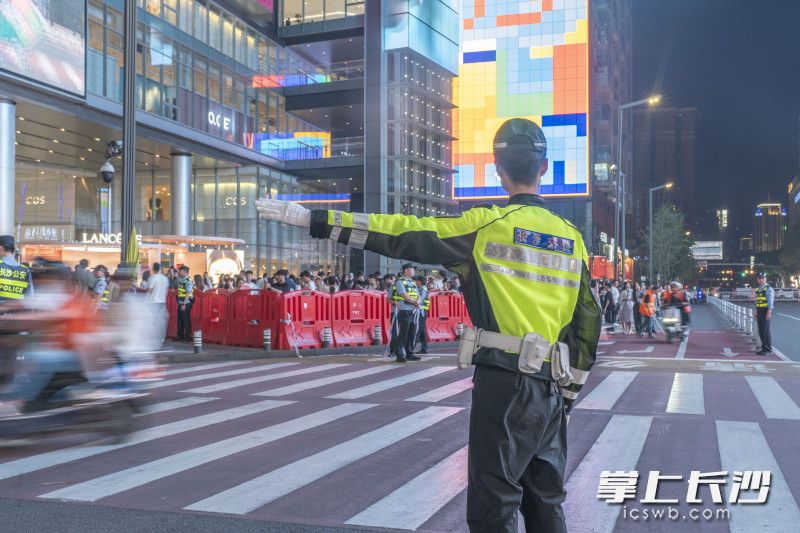 “请按指示有序通行！”在黄兴南路步行街，长沙交警正灵活疏导如织车流。