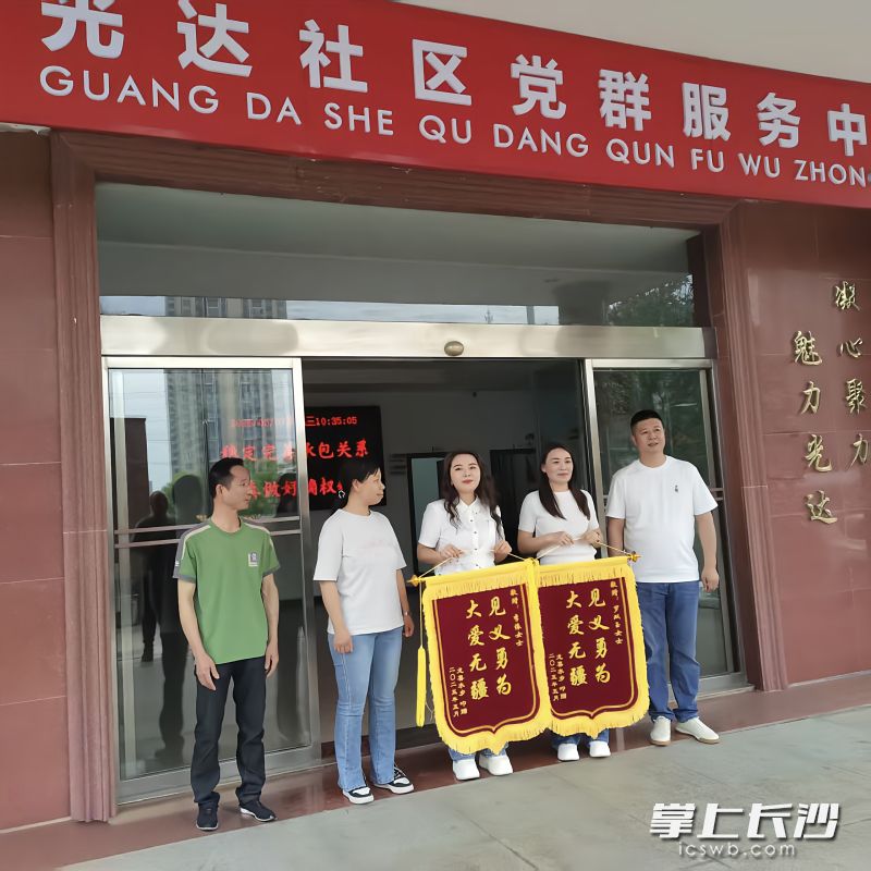 获救家庭将印有“见义勇为 大爱无疆”的锦旗交到施救者手中。均为黄兴镇 供图