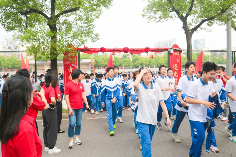 毕业生们依次跨过鲜花装点的“未来之门”，门铃轻响，彩纸纷扬。