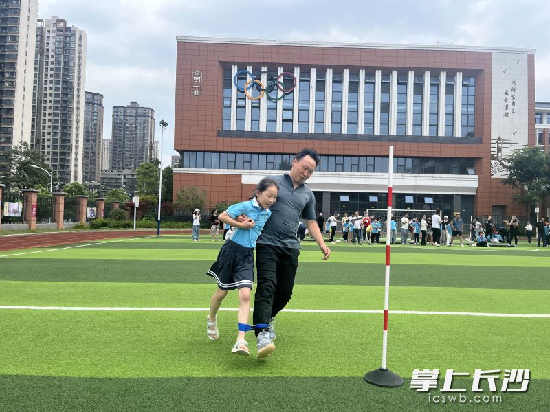 亲子运运会上，孩子和家长一起开心运动。