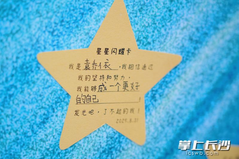 在教师指导下学生们将心愿写在星形卡片上。