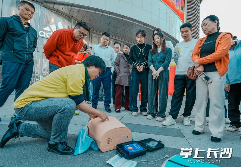 心肺复苏教学点前，大家围拢起来，认真学习按压技巧。