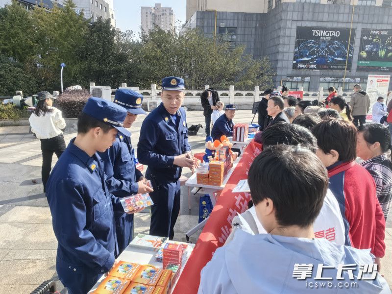 消防宣传员在向市民发放宣传资料。 长沙晚报通讯员 董文文 摄