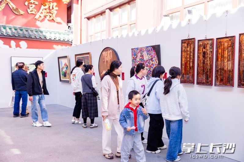 市民、游客驻足观看展览作品。