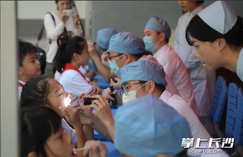 长沙市口腔医院的医护人员为孩子们进行公益口腔健康筛查。长沙晚报全媒体记者 杨蔚然 摄 长沙市口腔医院的医护人员为孩子们进行公益口腔健康筛查。长沙晚报全媒体记者 杨蔚然 摄