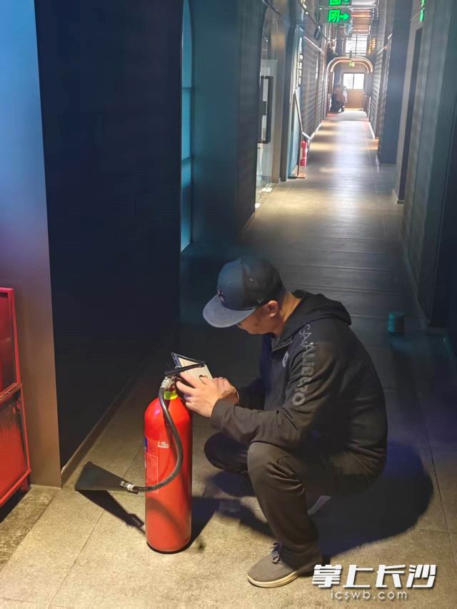 检查组工作人员正细致检查消防设施器材是否完好有效。