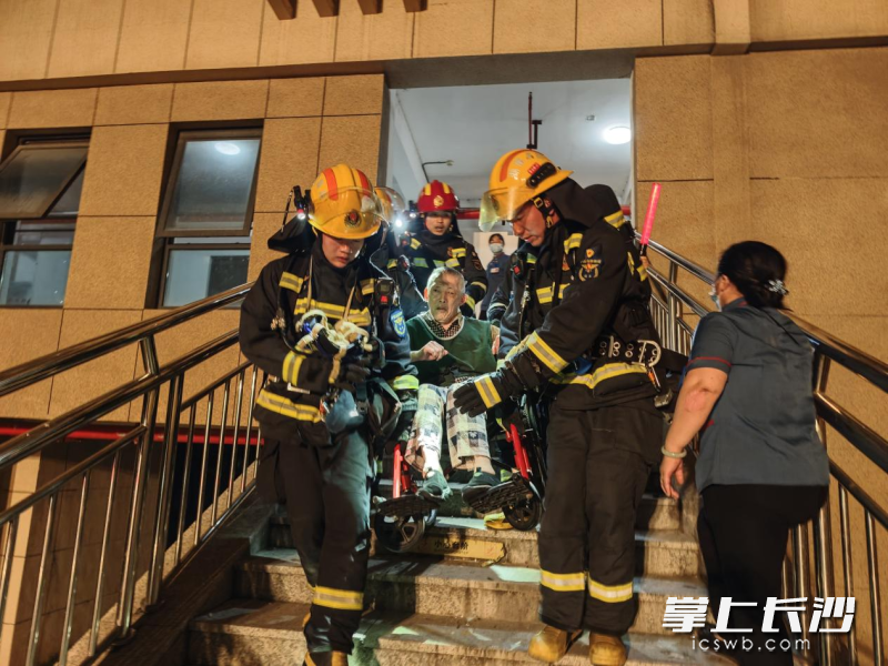 消防员协助行动不便的老人进行疏散。 长沙晚报通讯员 刘鑫 摄