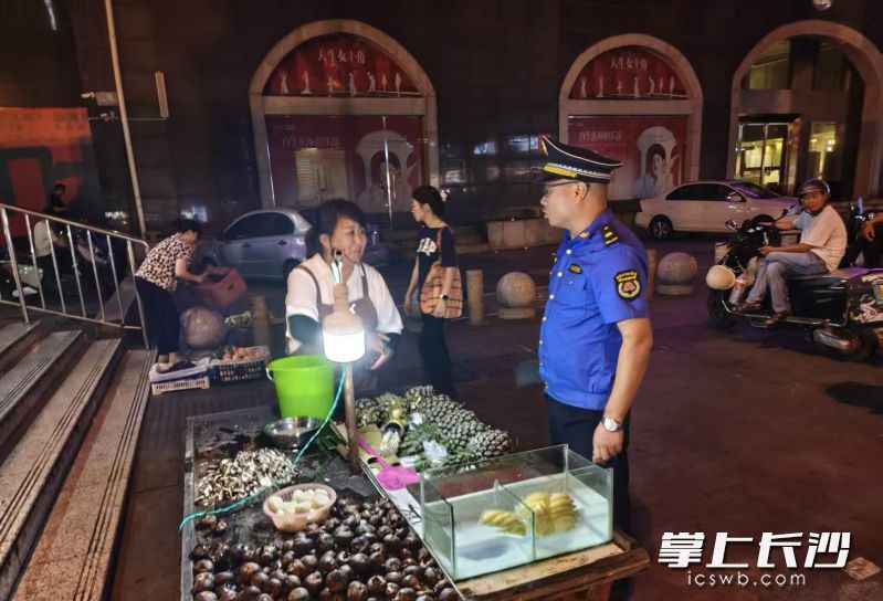执法队员对考点周边的摊贩开展宣传，告知考试期间的市容与噪声管控要求。 均为长沙晚报全媒体记者蒋志斌摄
