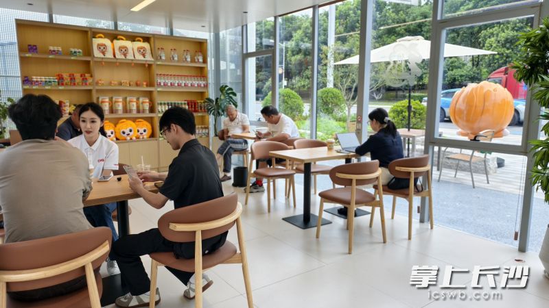 车主喝着咖啡，让爱车和身心一起“充电”。