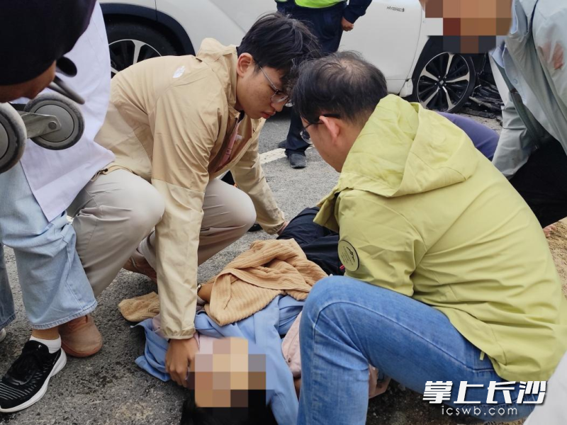 车医生和儿子一起将颈椎、腰椎受伤的患者平移到安全平整的地面躺平,避免二次受伤。 均为受访者供图 车医生和儿子一起将颈椎、腰椎受伤的患者平移到安全平整的地面躺平,避免二次受伤。 均为受访者供图