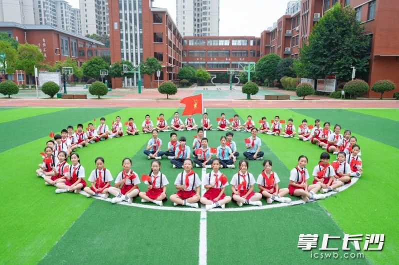 操场上，红领巾映衬国旗红。