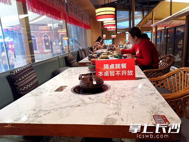 “进门要测温消毒,还安排了隔桌就餐,感觉防护很到位,吃得也放心。”顾客说。吴梦珊 摄